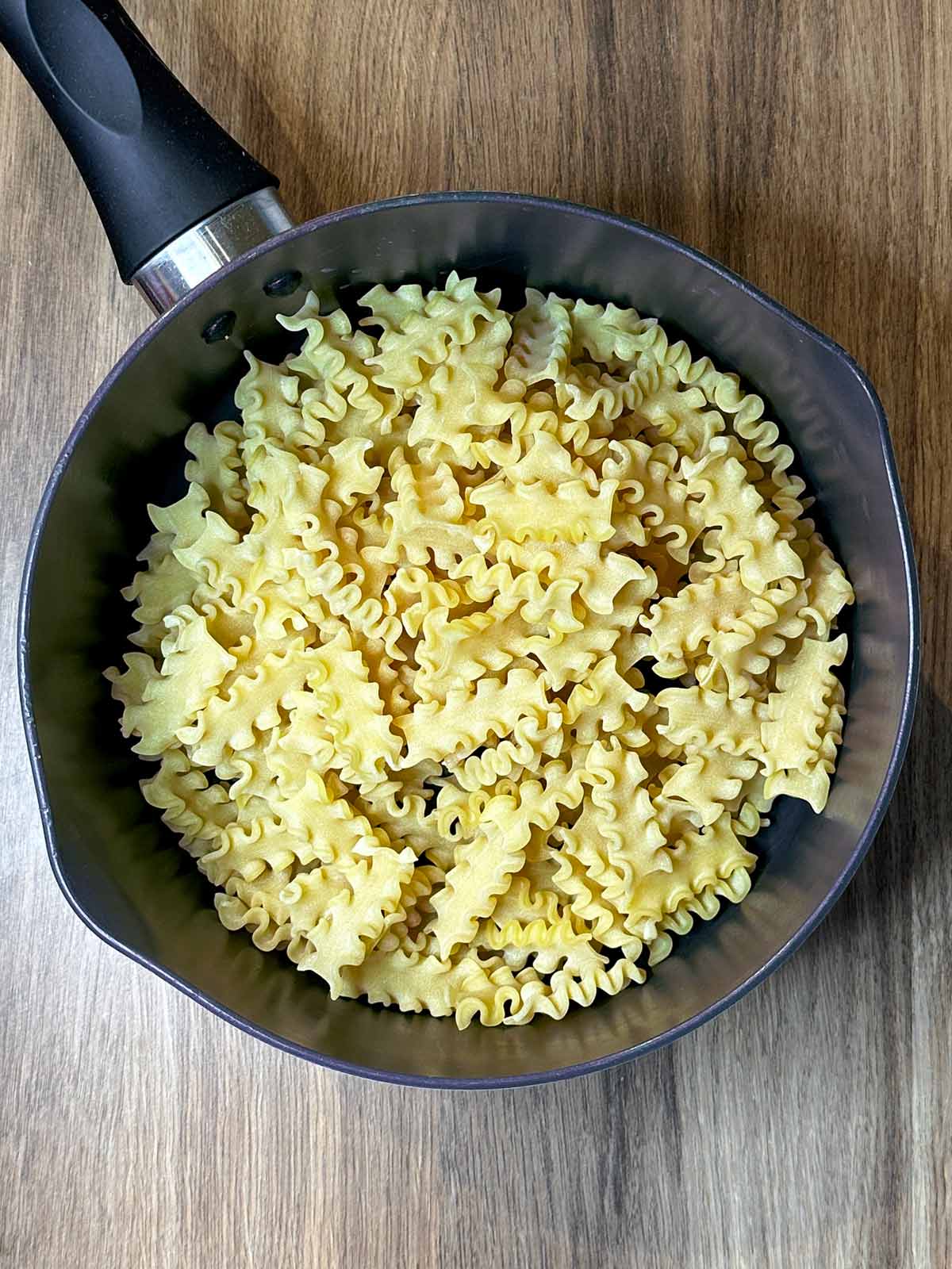 A saucepan with pasta in it.