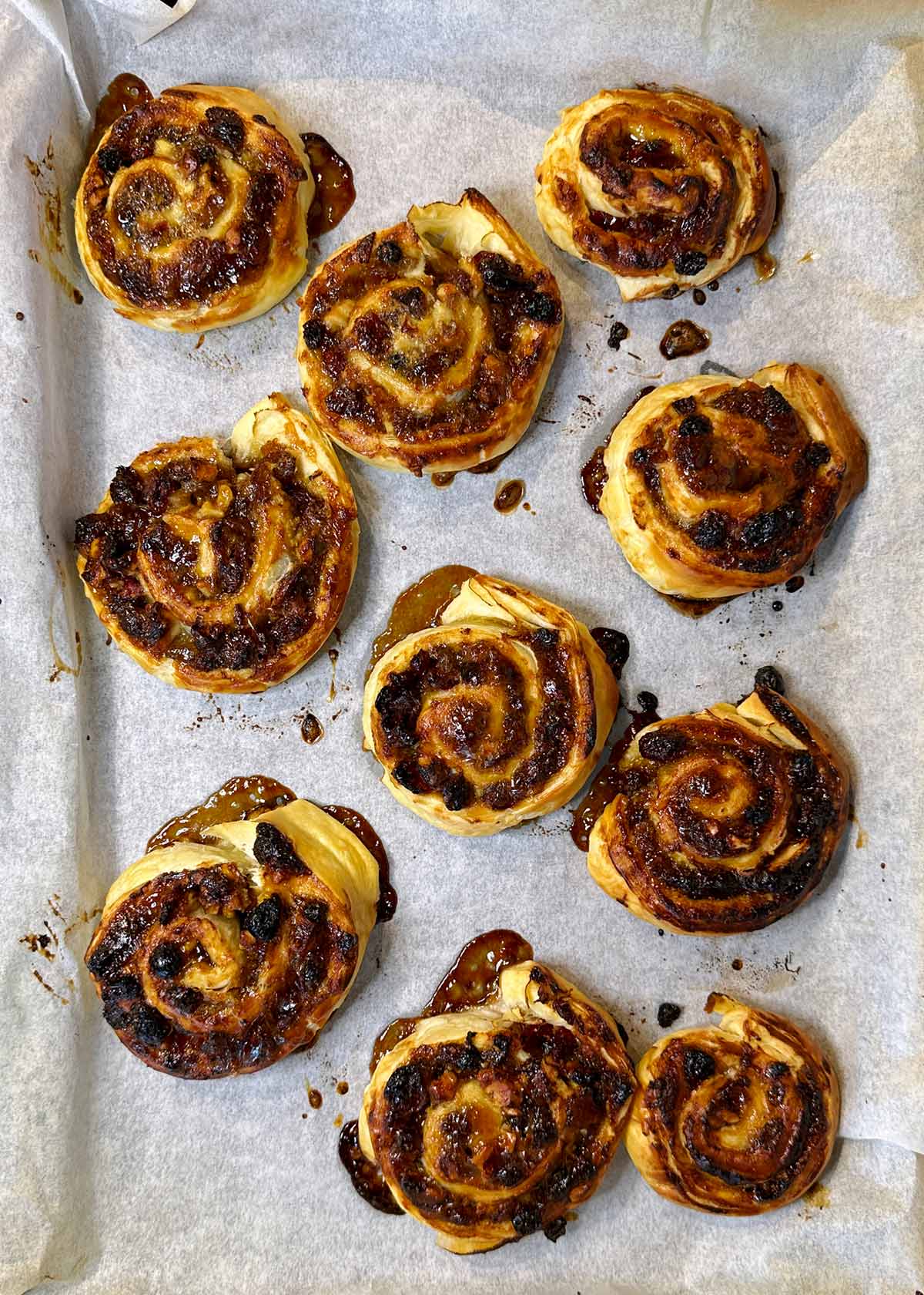 Cooked pinwheels on the baking tray.