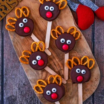 Six Oreo reindeer on a wooden serving board.