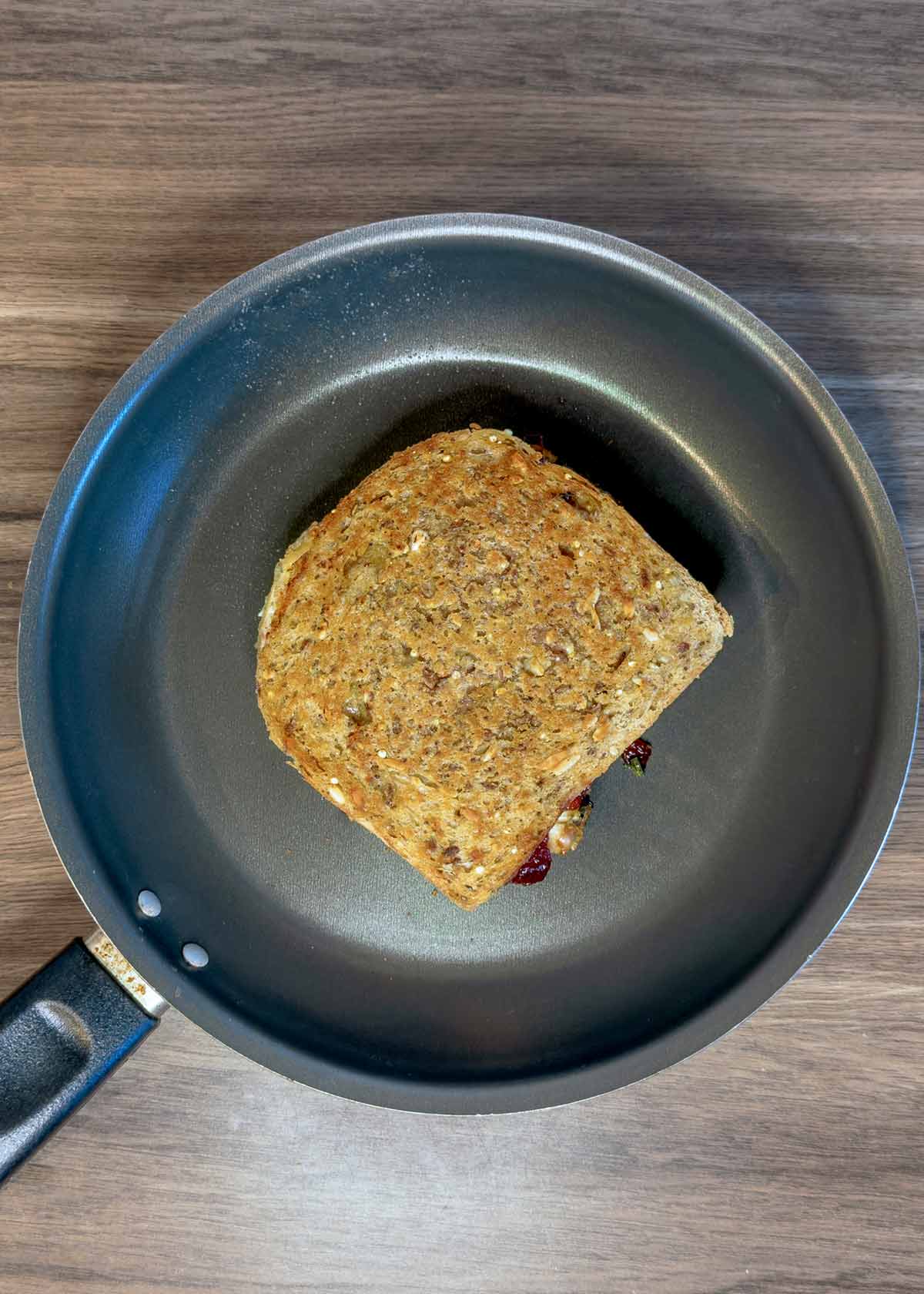 A sandwich frying in a pan.