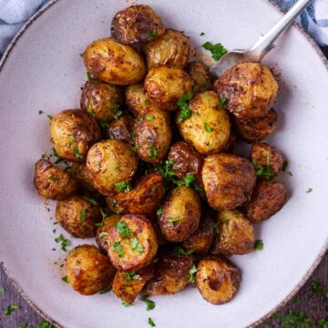 A plate of air fryer baby potatoes with a fork.