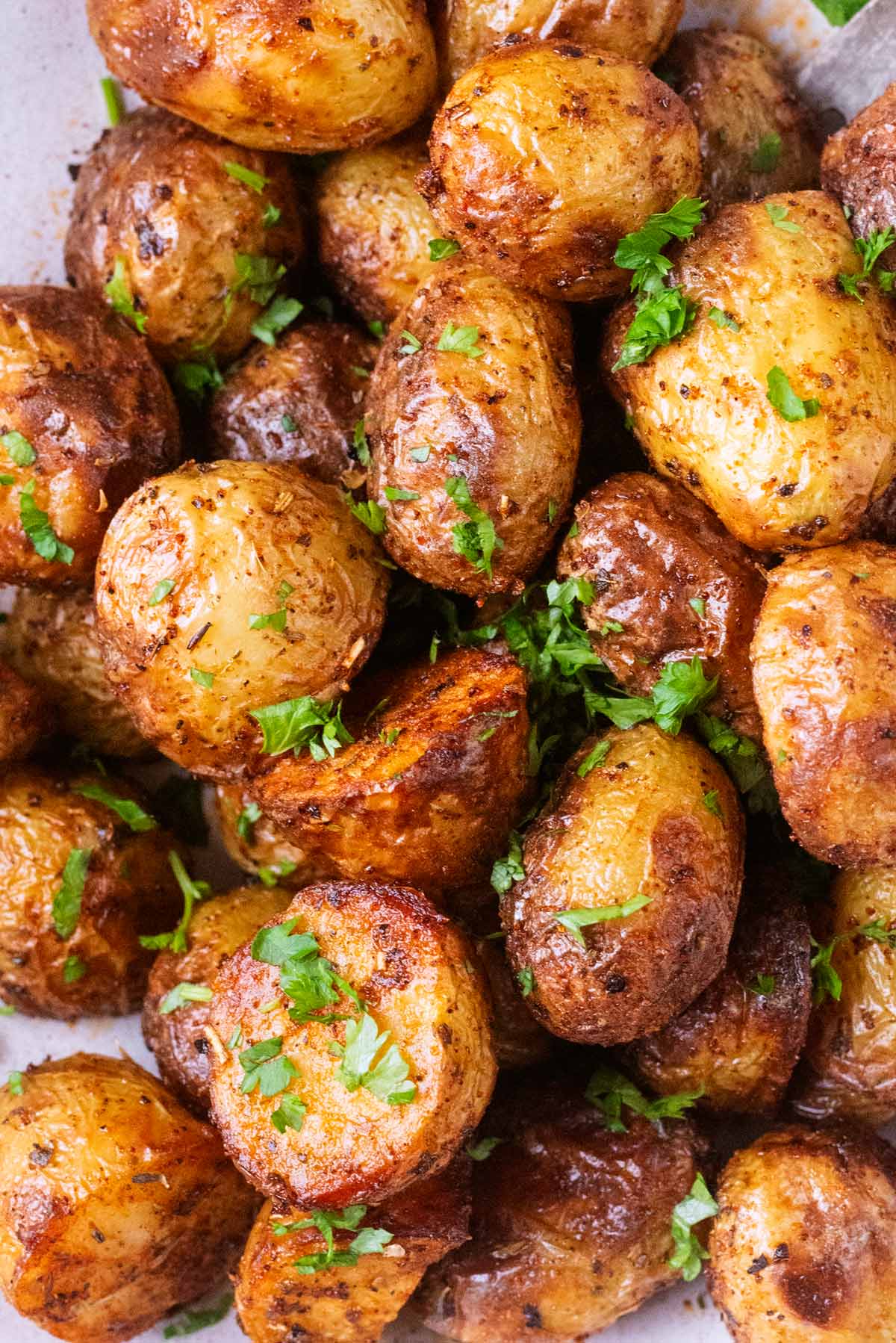 Cooked new potatoes with chopped parsley sprinkled over them.