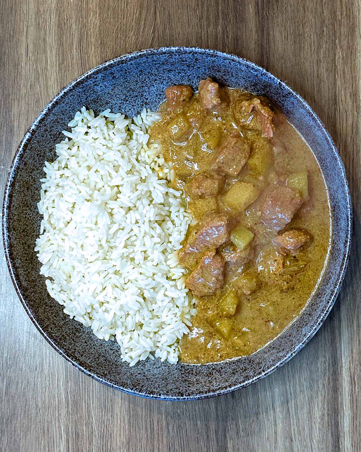The curry in a bowl with rice.