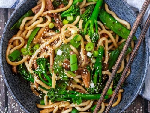 A bowl of Yaki Udon with a pair of chopsticks across the bowl.