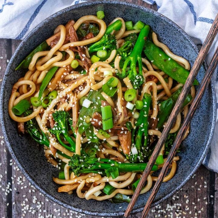 A bowl of Yaki Udon with a pair of chopsticks across the bowl.