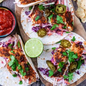 Air Fryer Fish Tacos next to a small bowl of salsa.