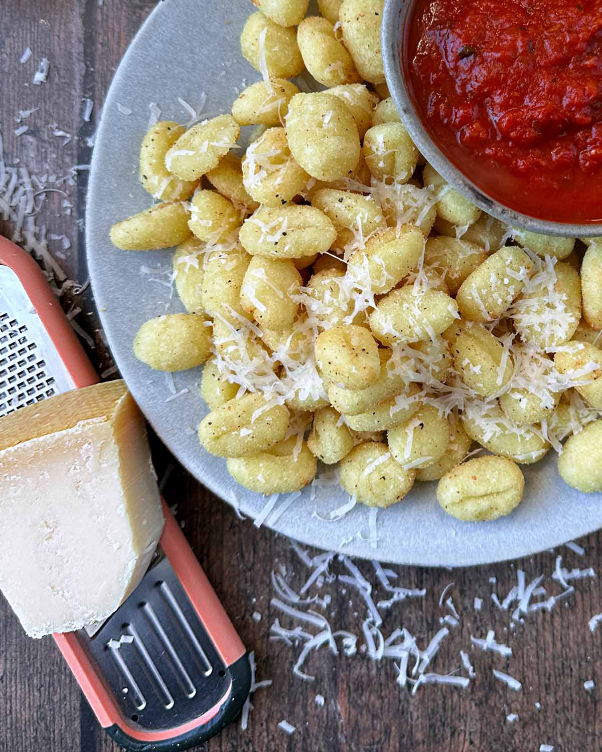Parmesan grated on top of the cooked gnocchi.