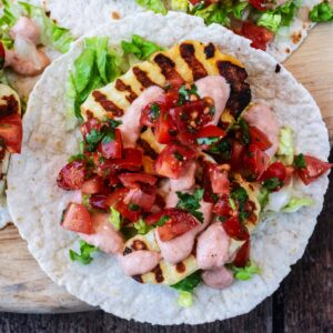 Halloumi tacos on a wooden serving board.