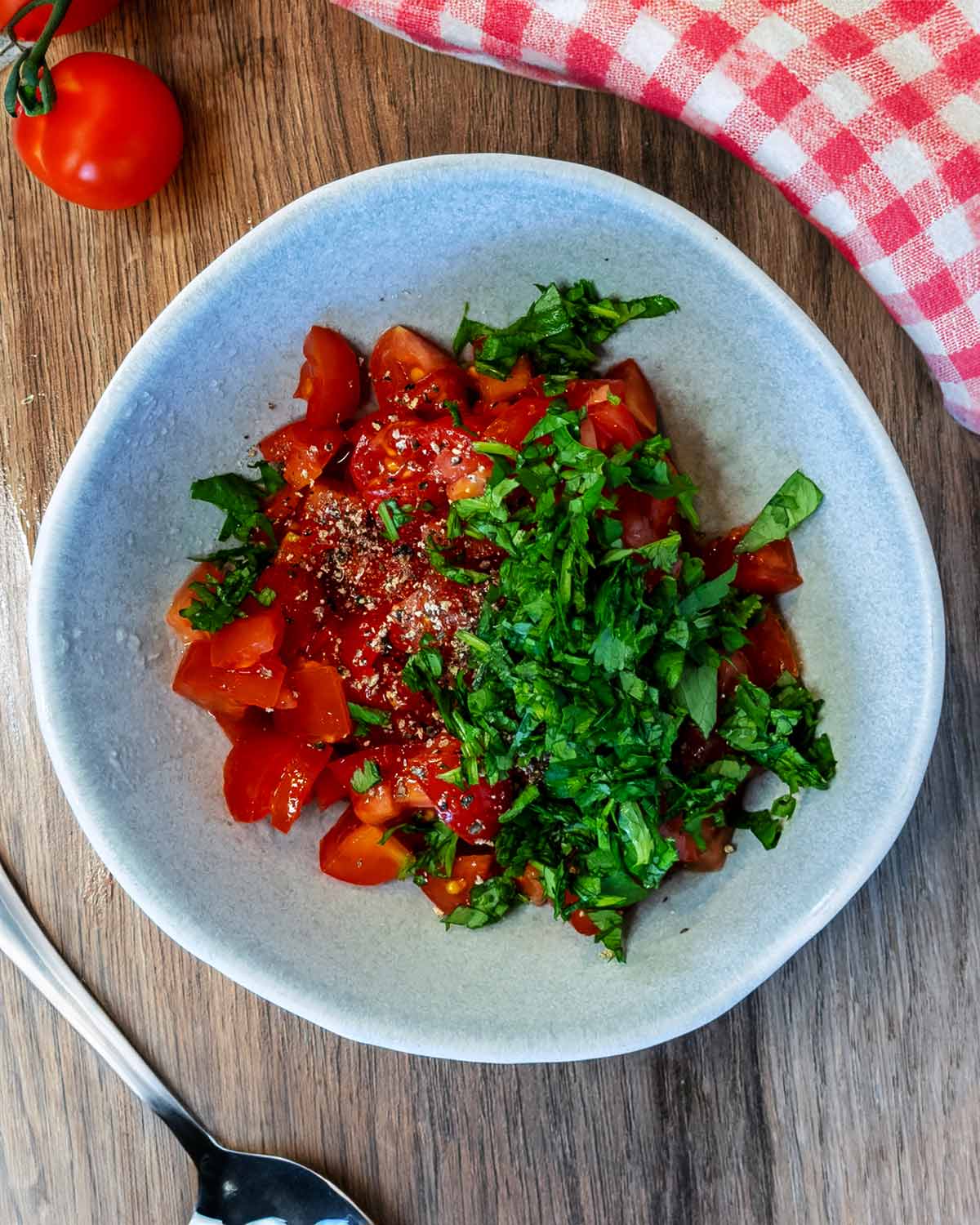 Diced tomatoes and chopped coriander in a bowl.