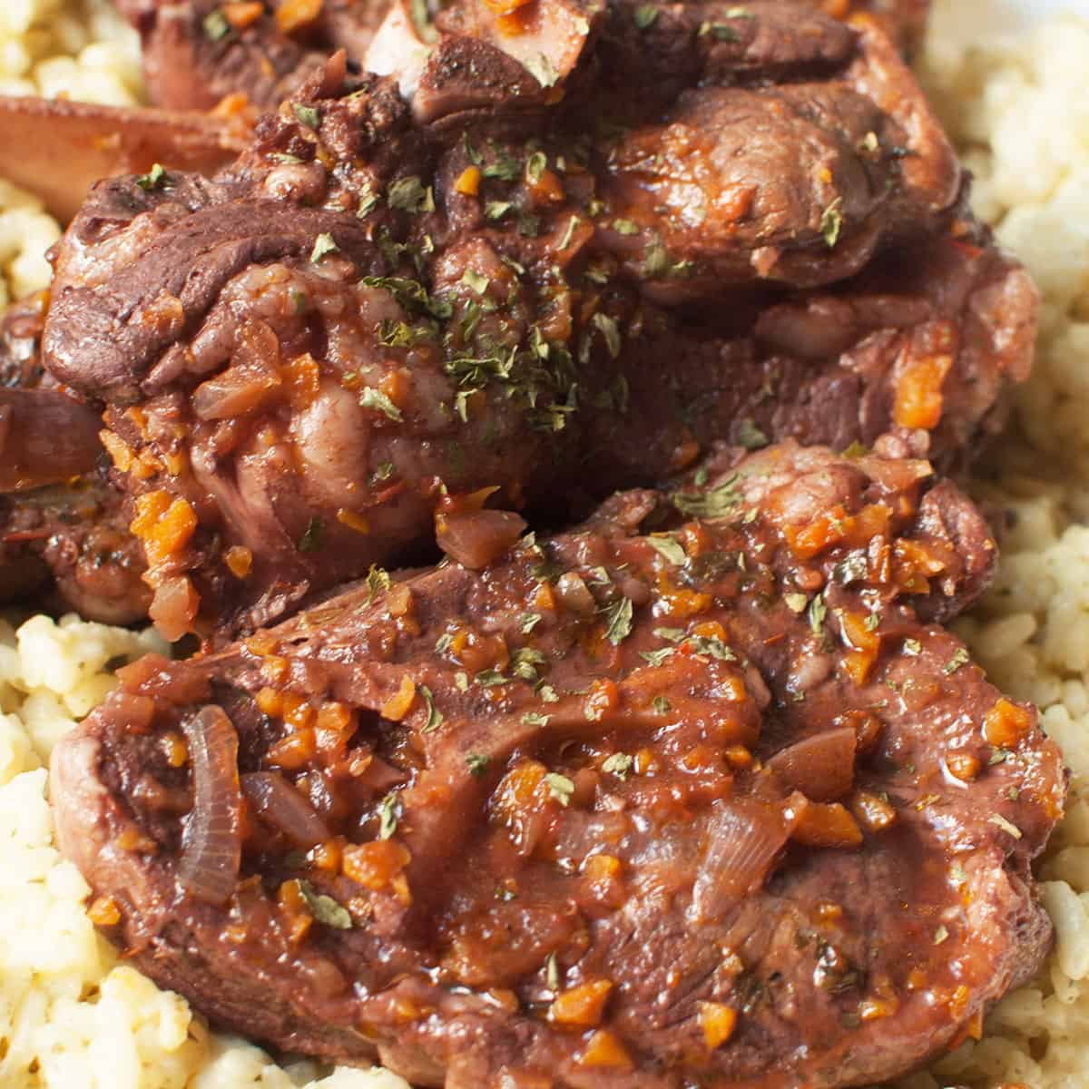 Pieces of braised lamb and onions on a bed of couscous.