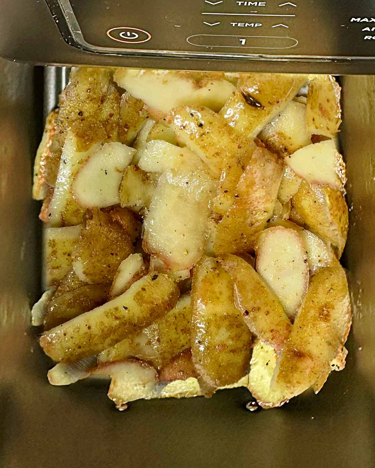 Potato peelings in an air fryer basket.