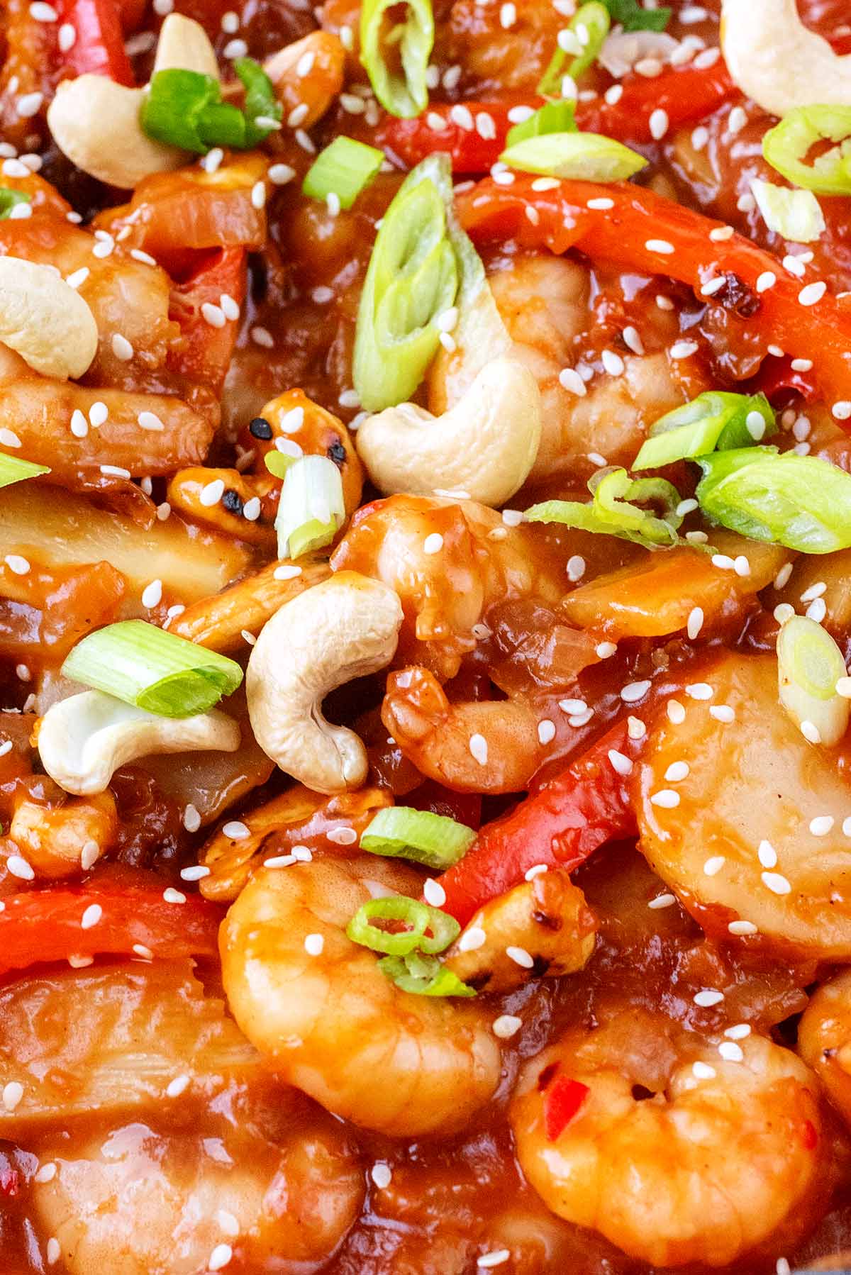 Cashew nuts, sliced spring onions and sesame seeds on top of kung po prawns.