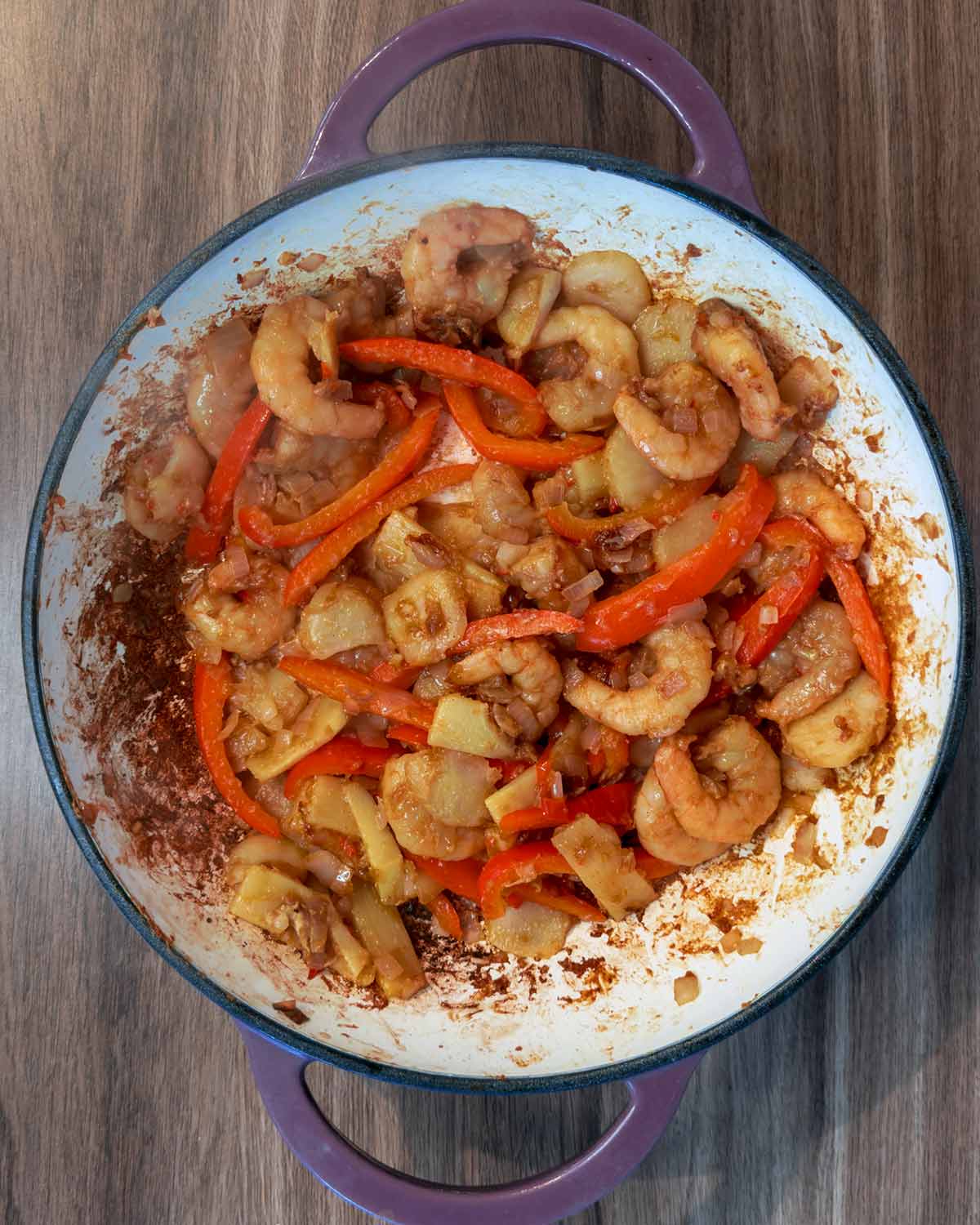 cooked prawns and vegetables in the pan.