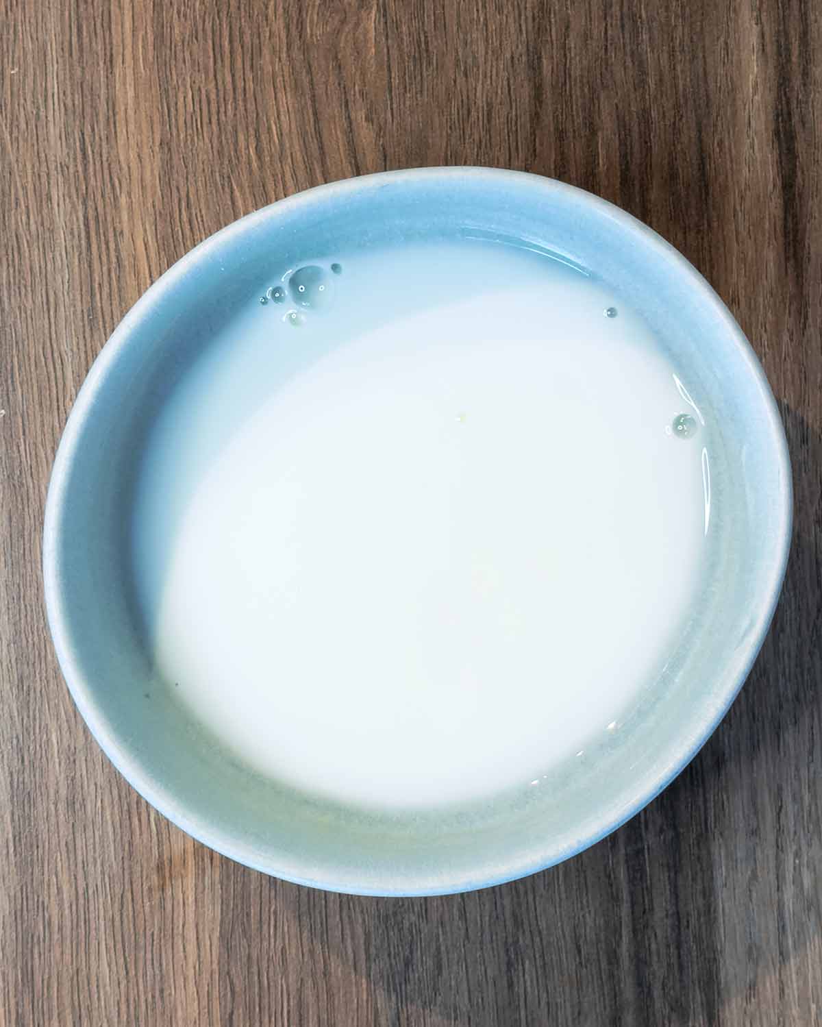 A small bowl containing a milky liquid.