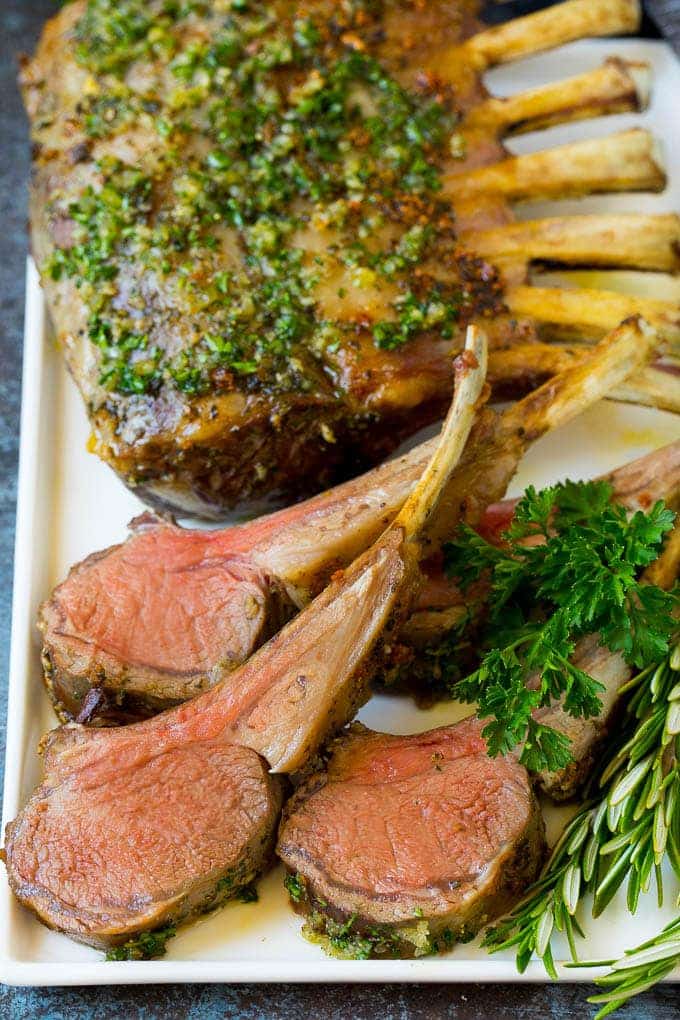 A rack of lamb and lamb cutlets on a plate.