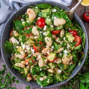 Butter Bean Salad in a large bowl with a spoon in it.