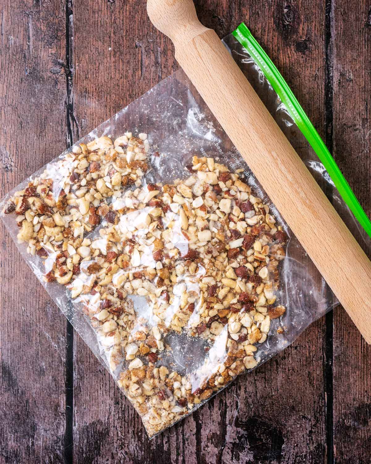 A clear ziplock bag containing crushed nuts.
