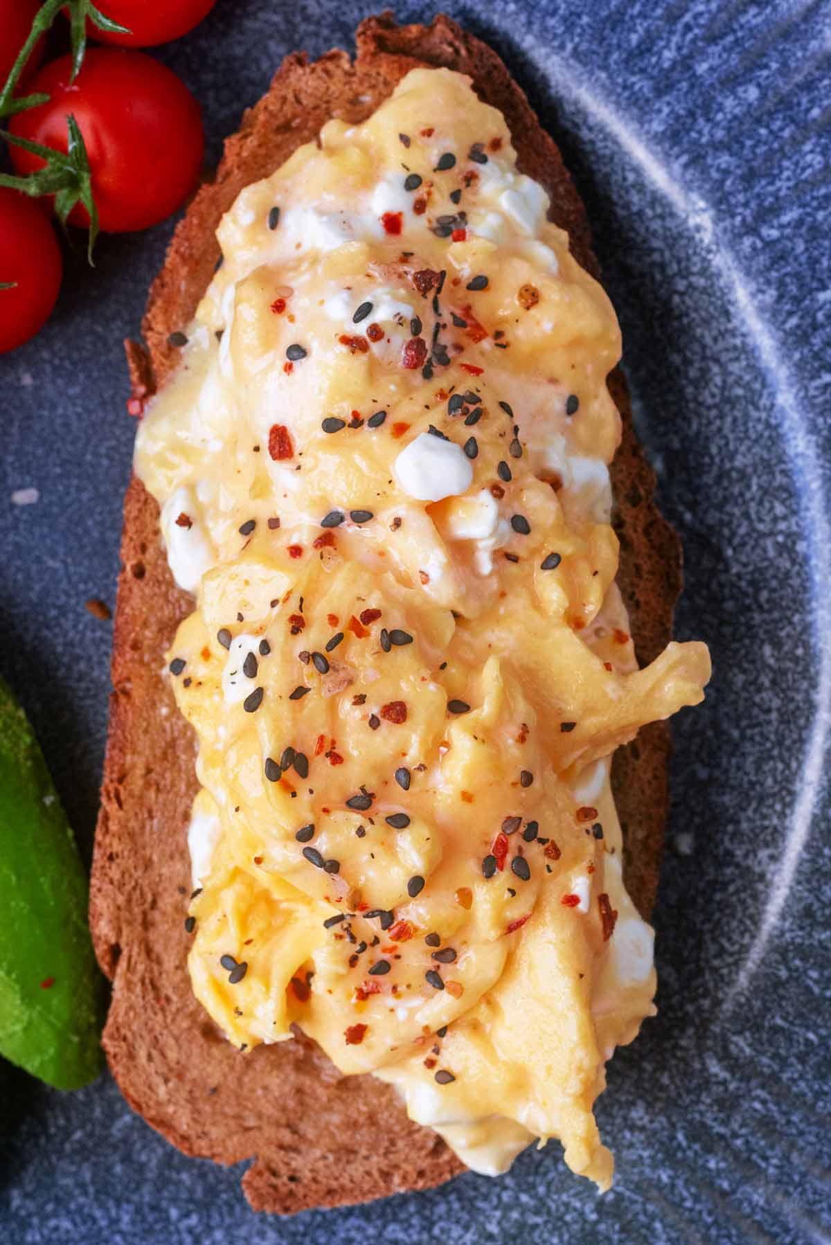 Scrambled eggs mixed with cottage cheese and topped with seasoning.