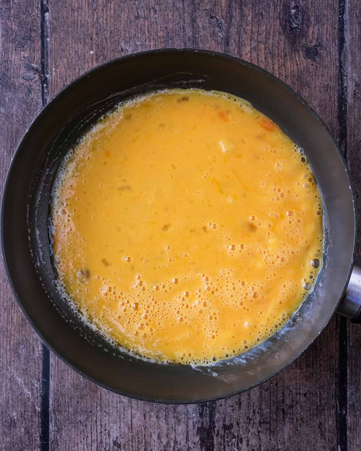 Whisked eggs in the frying pan.