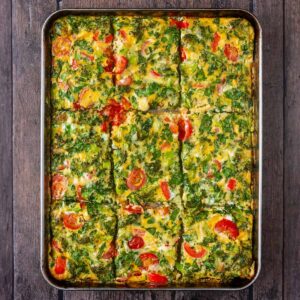 Sheet pan eggs on a wooden surface.