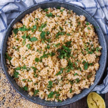 A large bowl full of cooked brown rice and quinoa.