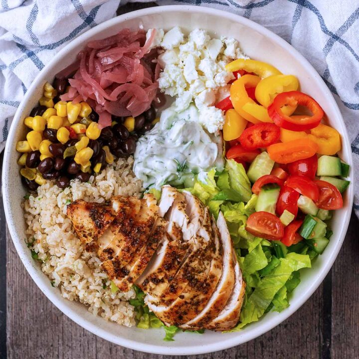 A chicken protein bowl next to a checkered towel.