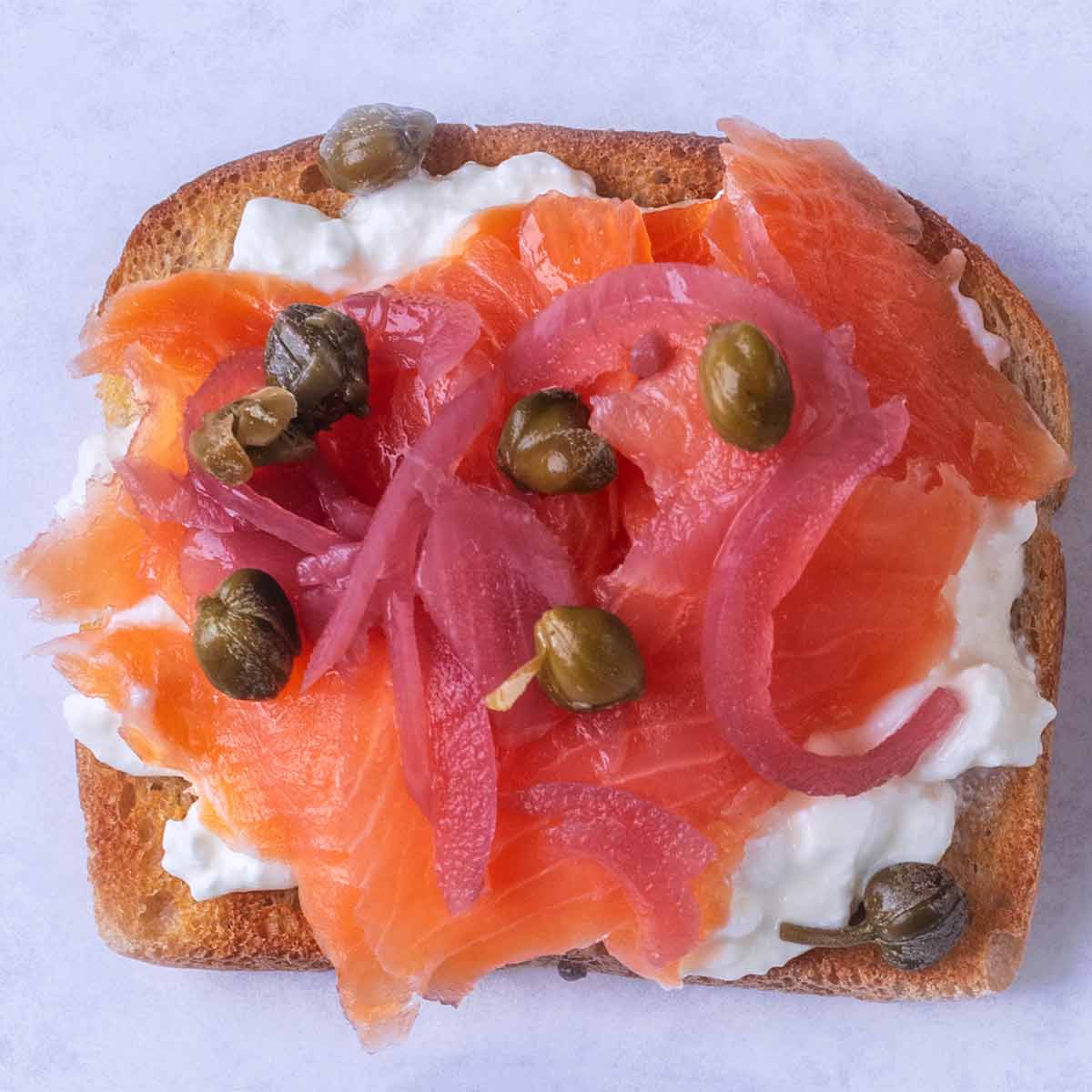 Smoked salmon, pickled red onions and capers on top of cottage cheese on toast.
