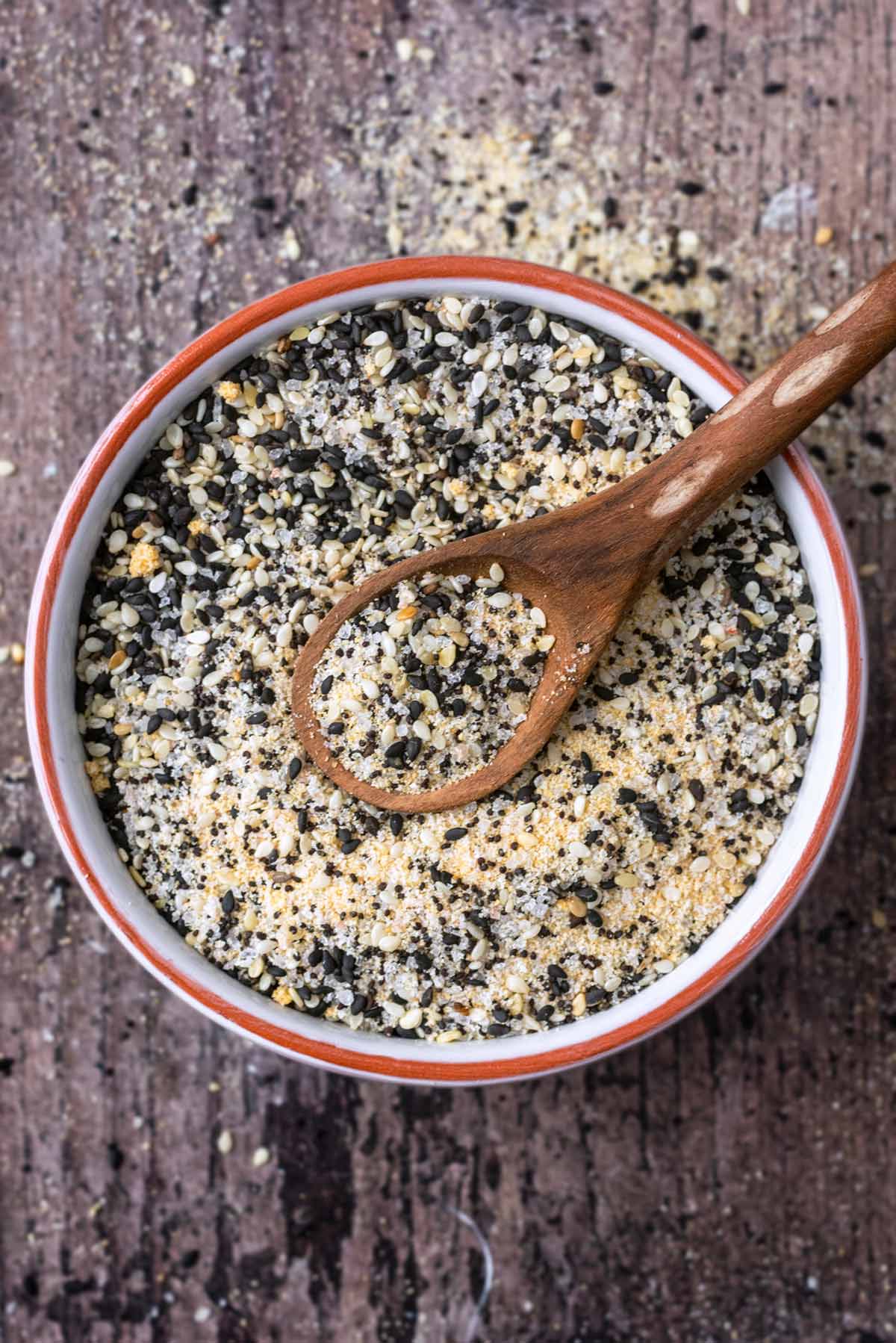 A bowl of sesame seed based seasoning with a spoon in it.