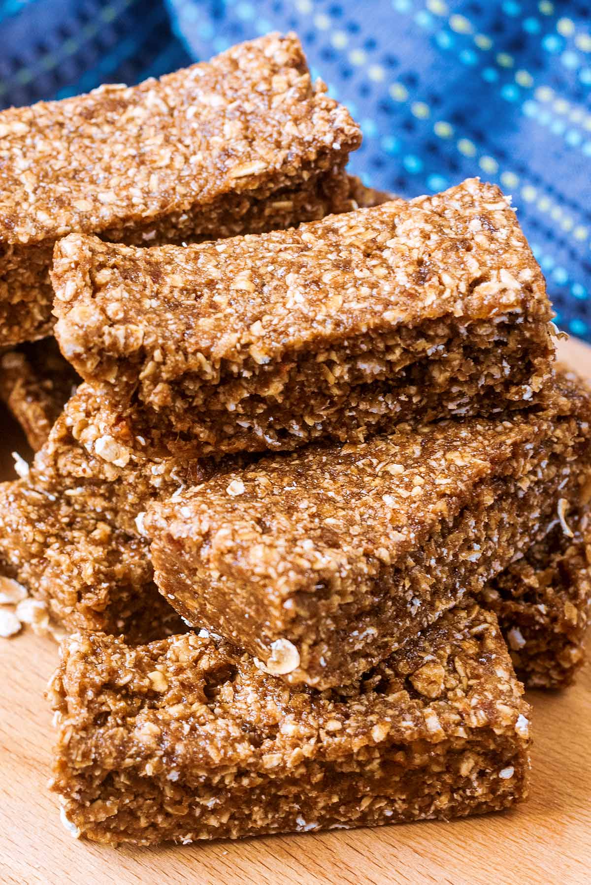 A stack of protein oat bars on a wooden board.