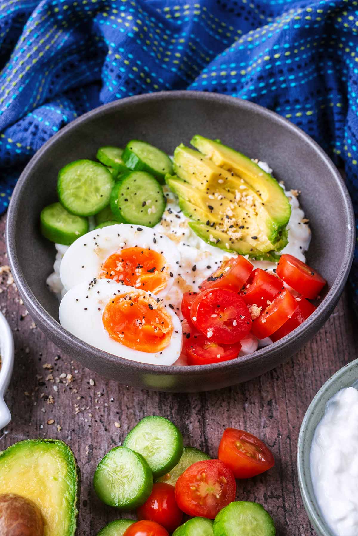 Cottage cheese, egg and salad in front of a blue towel.