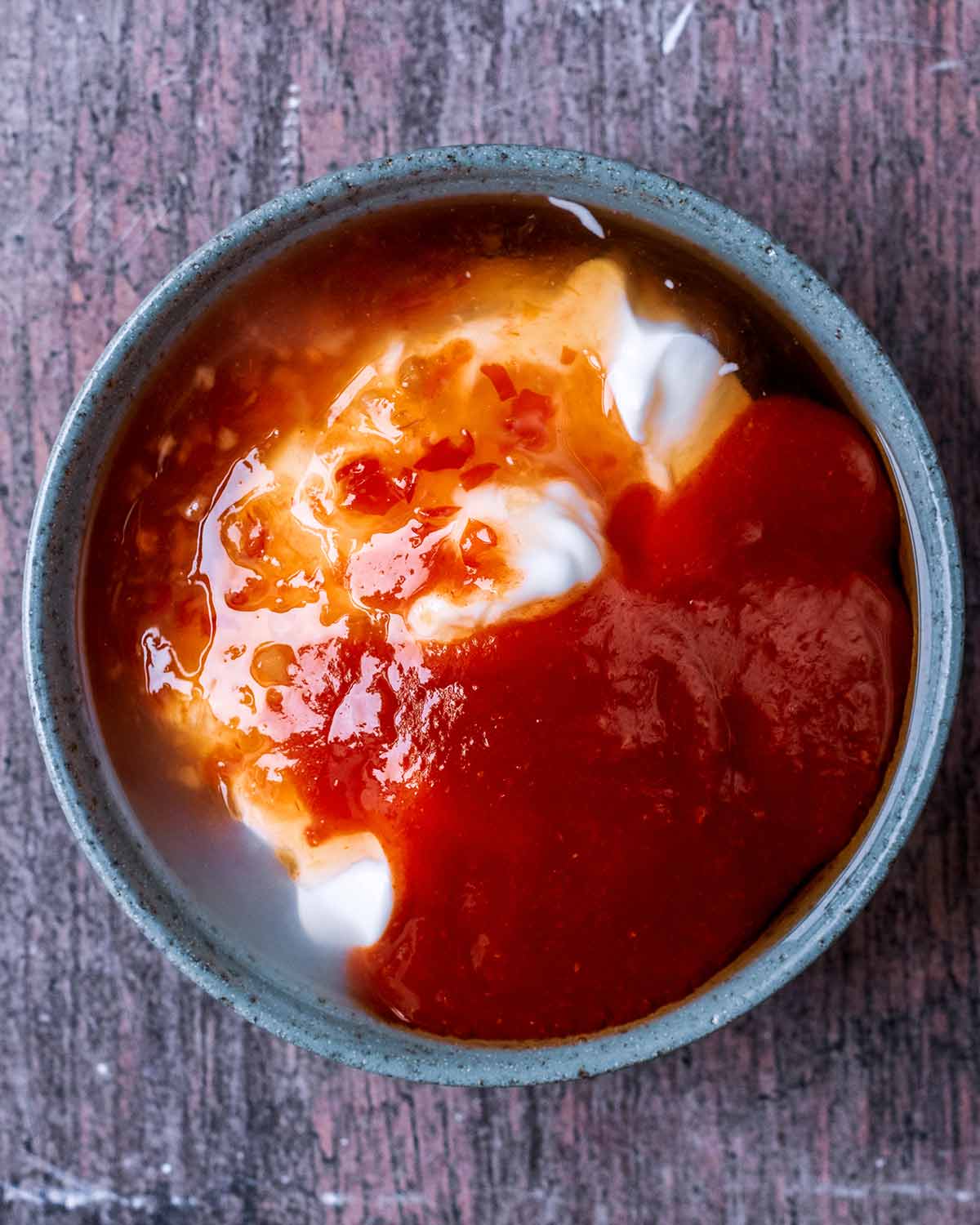 Yogurt and chilli sauce in a small bowl.