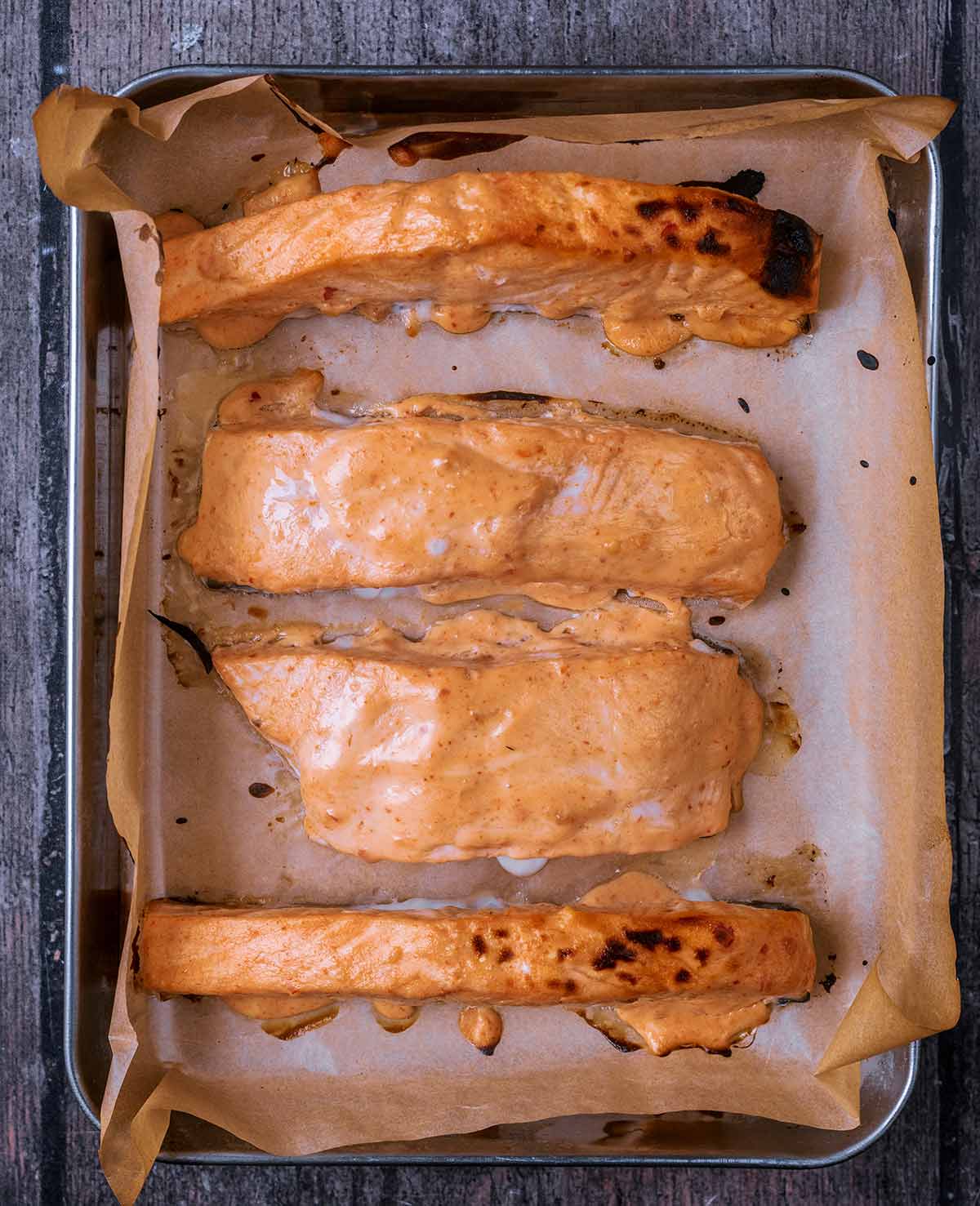 Cooked bang bang salmon on the baking tray.