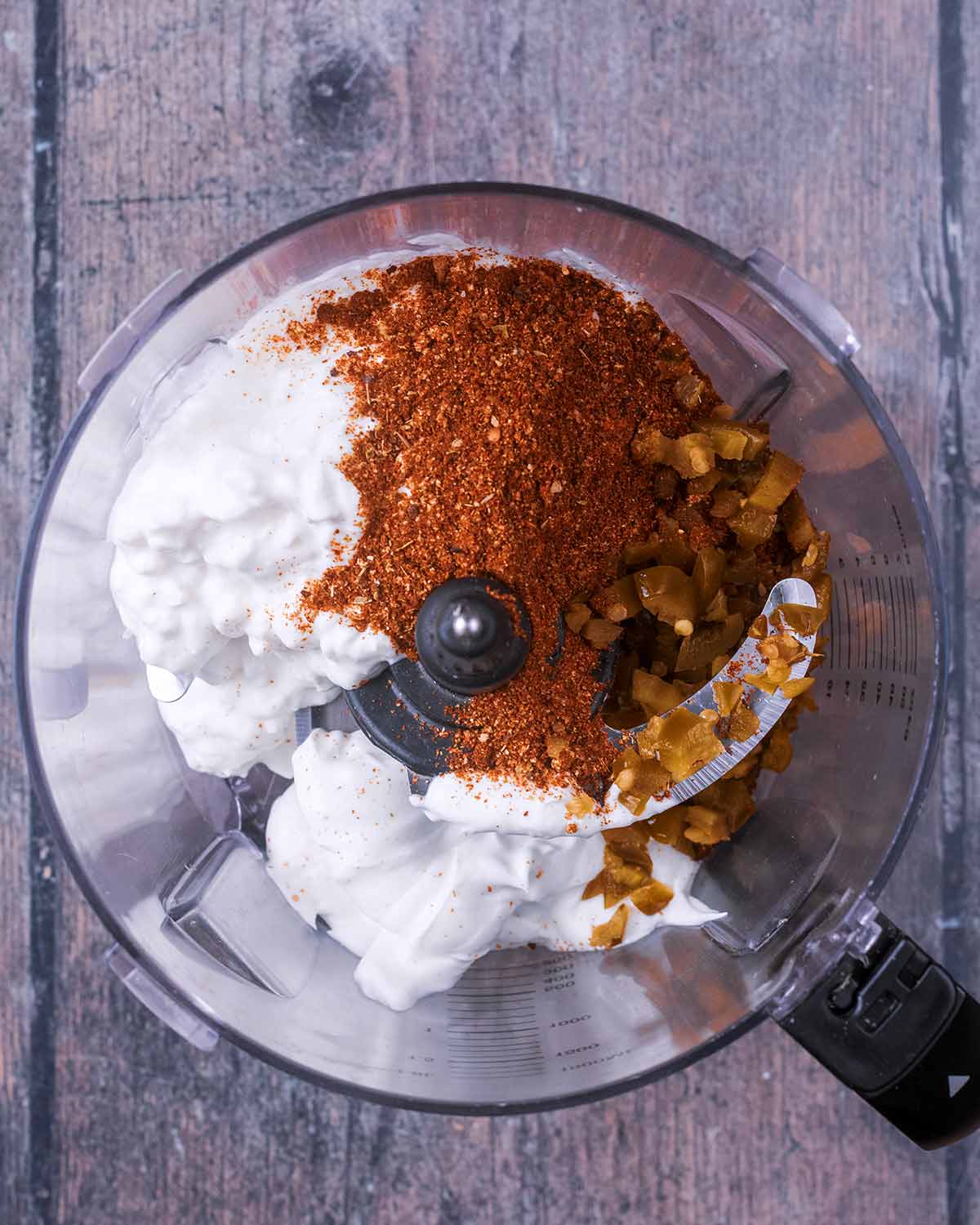 A blender containing cottage cheese, yogurt and seasoning.