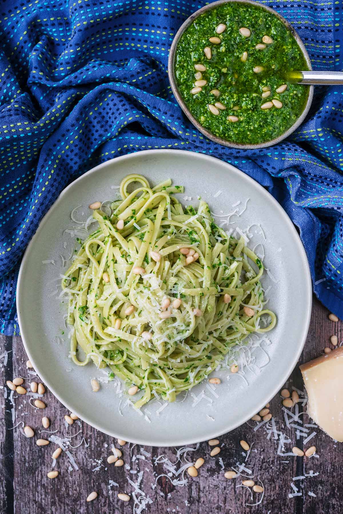 A plate of cooked linguine mixed with pesto.