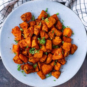 Air Fryer Sweet Potato Cubes on a round grey plate.