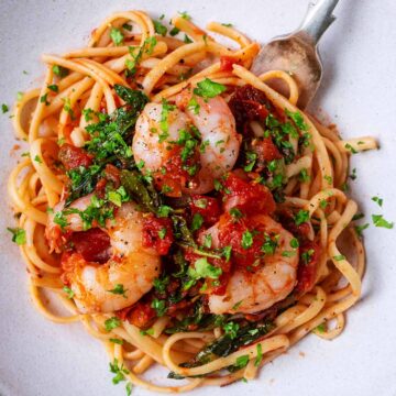 Chill prawn linguine on a plate with a fork.