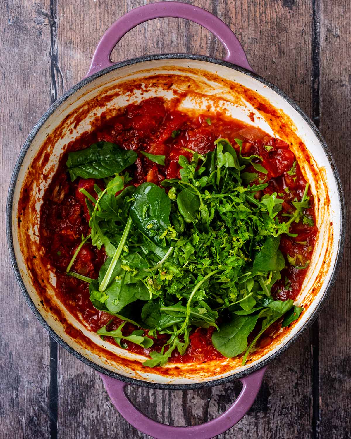 Spinach, watercress and rocket added to the pan.