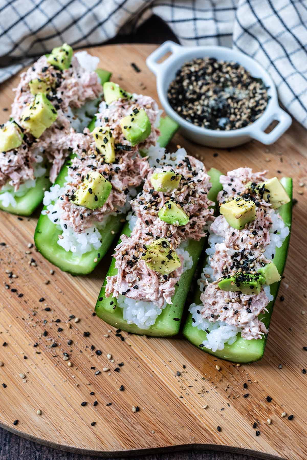 Four cucumber quarters filled with sushi rice and tuna mayonnaise.