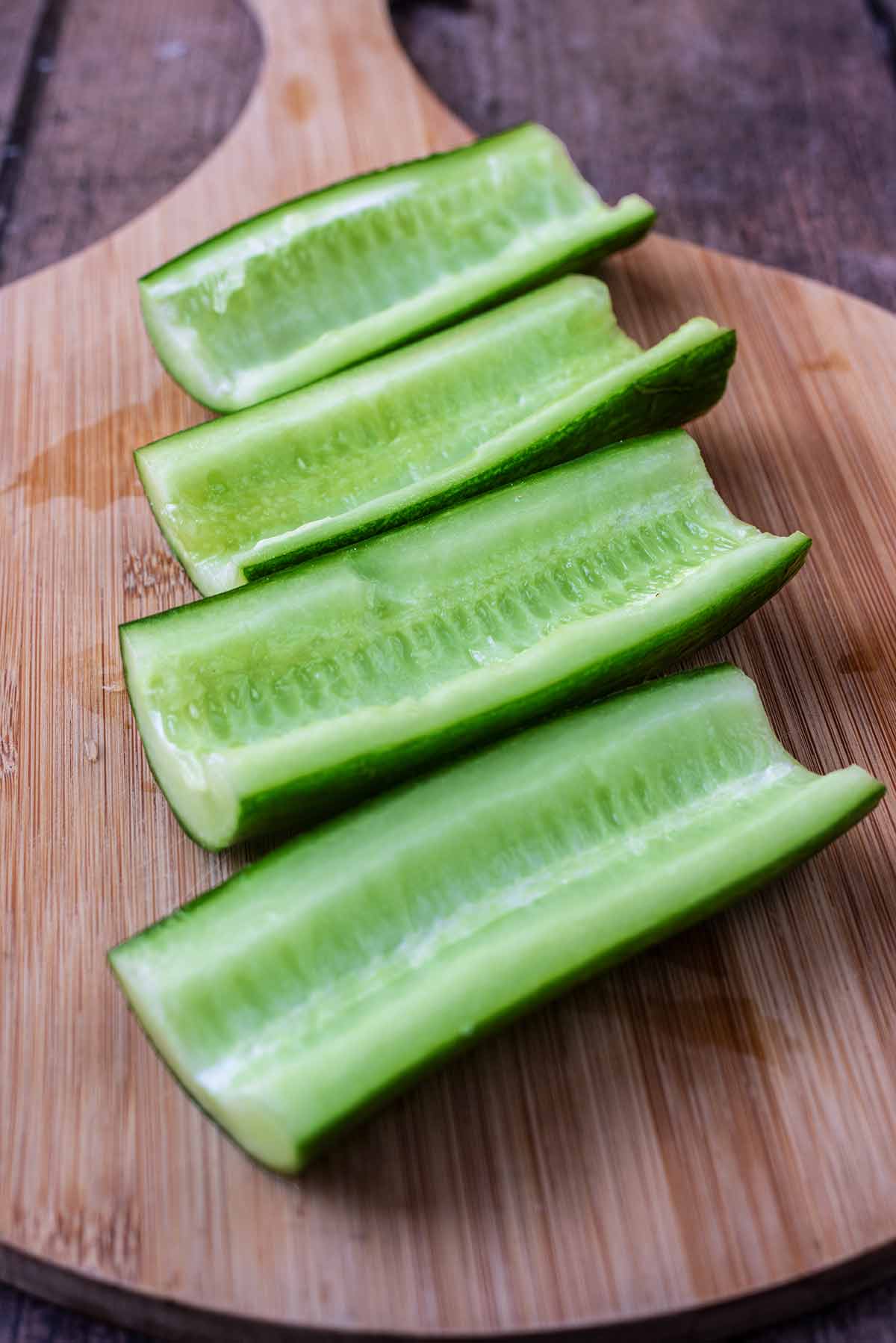 Quartered cucumber with the seeds scooped out.