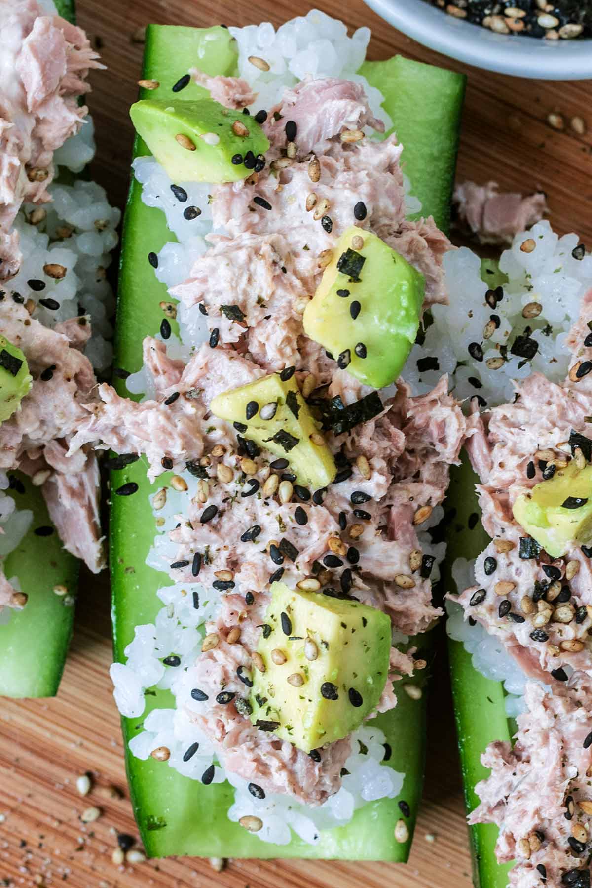 Tuna mayo, diced avocado and seasoning added on top of the rice.