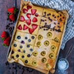 A tray of sheet pan pancakes on a wooden surface.