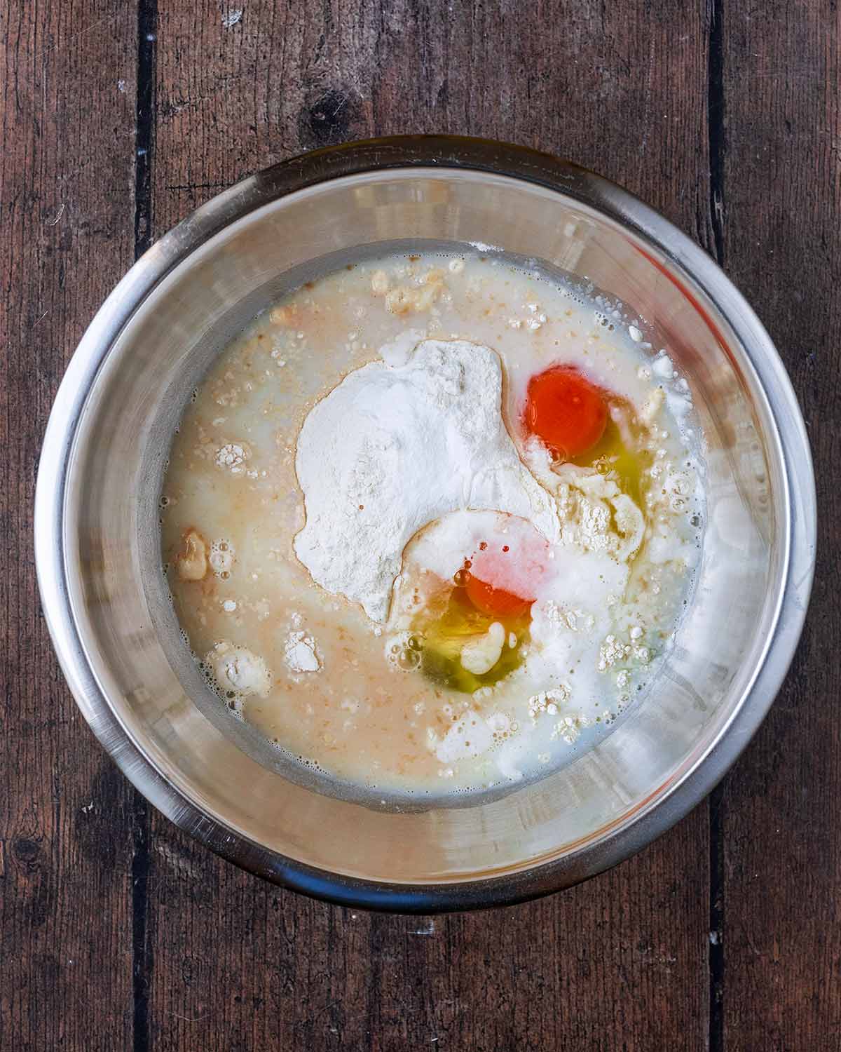 Flour, milk and eggs in a mixing bowl.