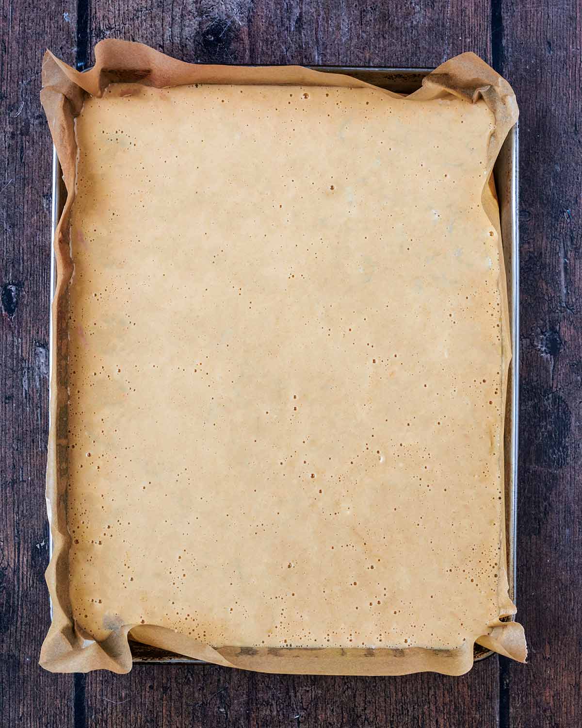 Pancake batter poured into a lined baking tray.