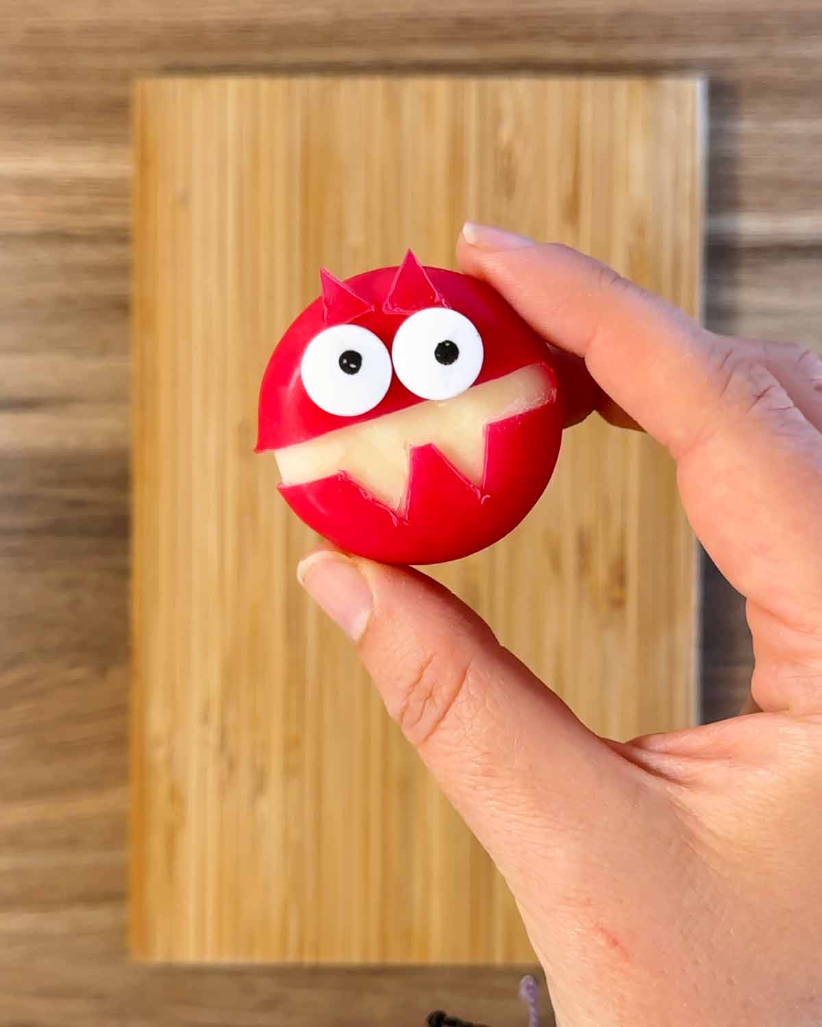 A Babybel with eyes and a mouth cut out of the wax.