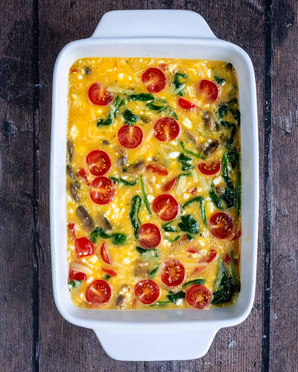 The egg and vegetable mixture poured into a baking dish.