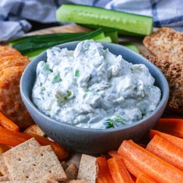 A bowl of Greek yogurt ranch dip surrounded by crudites.