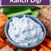 A bowl of Greek yogurt ranch dip with a text overlay title.