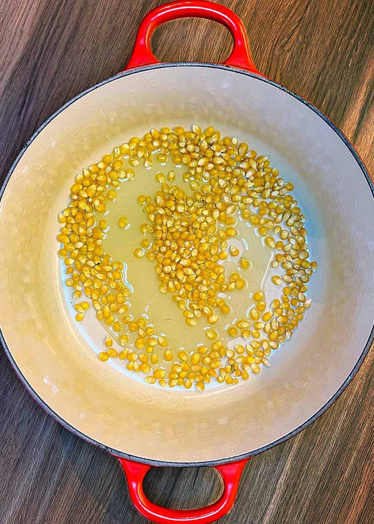 Popcorn kernels in a pan with oil.