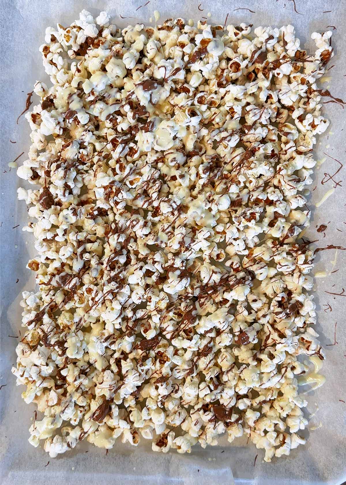 Melted chocolate drizzled over the popcorn.