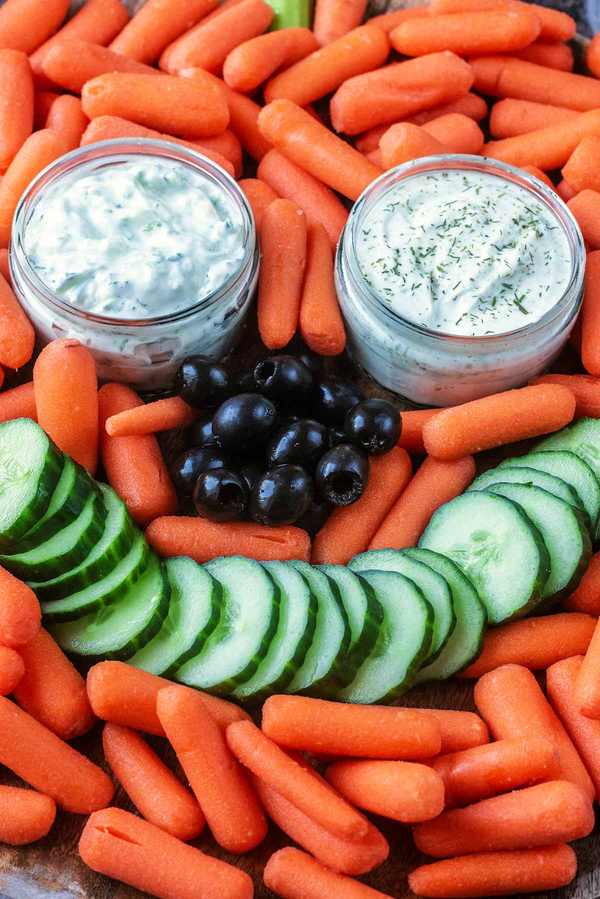 Carrots, olives and cucumber arranged to resemble a Jack O'Lantern face.